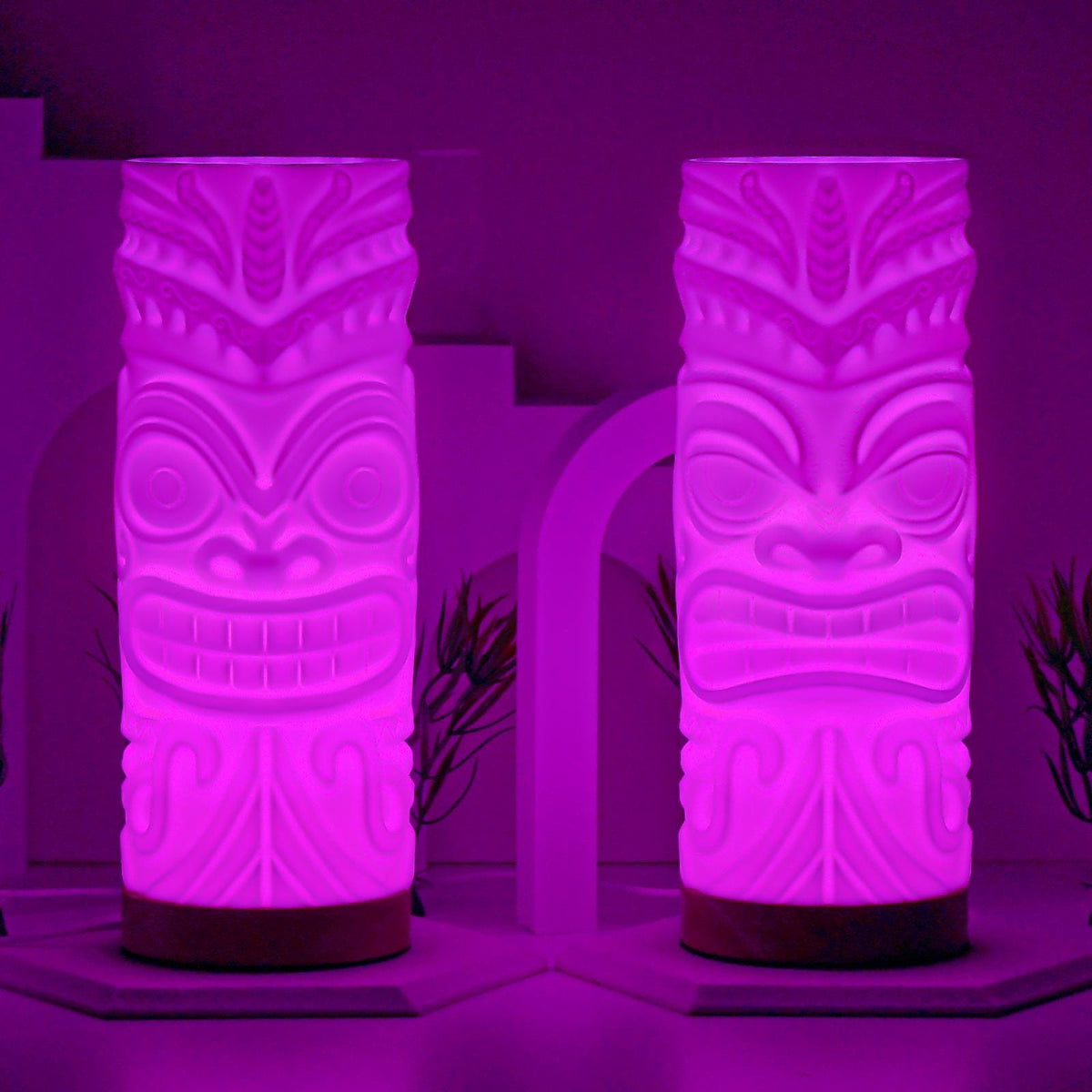 Pair of tiki lamps glowing purple