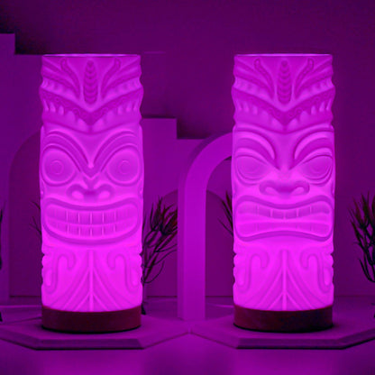 Pair of tiki lamps glowing purple